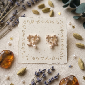 Elegant Pearl-Encrusted Ribbon Heart Studs